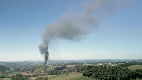 A wildfire in a field with smoke rising high in the sky. Aerial. 4K. Drone. Stock Footage 330982185