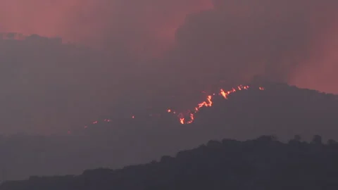 Wildfire in the mountains at nightfall Stock Footage 133203318