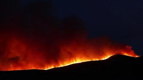 Wildfire at nighttime orange clouds black sky Stock Footage 134779000