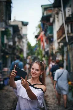 This will get so may likes on my page. a young woman taking selfies while Stock Photos