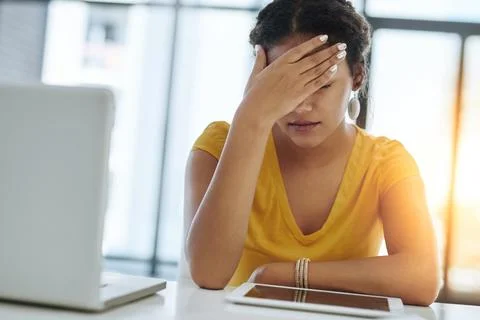 Will I ever see an end to these deadlines. a young designer looking stressed out Stock Photos