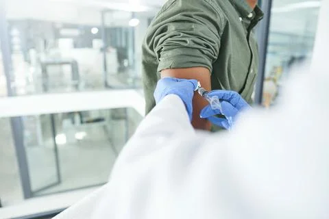 This will only take a second. an unrecognizable doctor giving a patient an Stock Photos