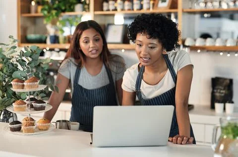 Will you be able to work this shift next week. Shot of two young women workin Stock Photos