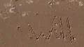 Will you marry me wedding proposal written in sand on beach by ocean HD Footage
