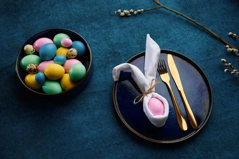 Willow branch, easter eggs in bowl and tableware Stock Photos