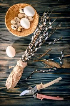 Willow branches and eggs on the table Stock Photos