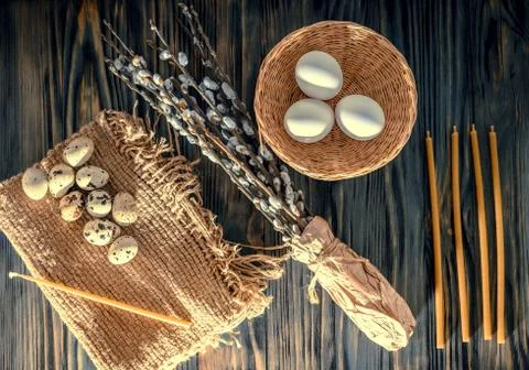 Willow branches and eggs on the table Stock Photos