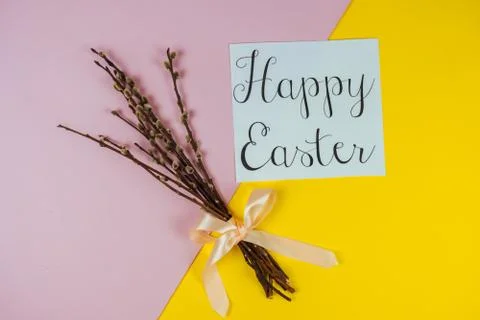 Willow branches and Happy Ester greeting card isolated on yellow and pink Stock Photos