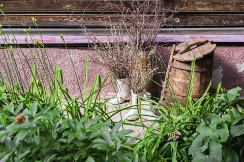 Willow branches are inserted into boots standing against the wall Stock Photos