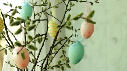 Willow branches decorated with Easter eggs stand in the open window. Stockbeeldmateriaal 235168033