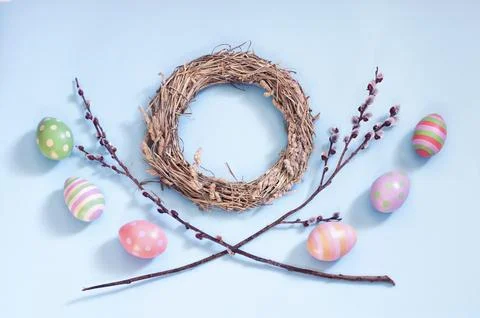 Willow branches, Easter eggs and a wreath on a blue background, spring Easter Stock Photos