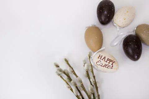 Willow twigs and Easter eggs are on a white isolated background.  Stock Photos