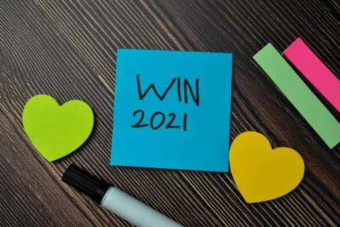 WIN 2021 write on sticky notes isolated on office desk. Stock Photos