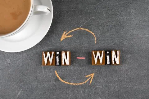 Win concept. Text and coffee mug on a dark board Stock Photos