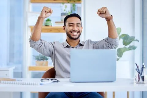 This win will be big for my business. a young businessman cheering while working Stock Photos