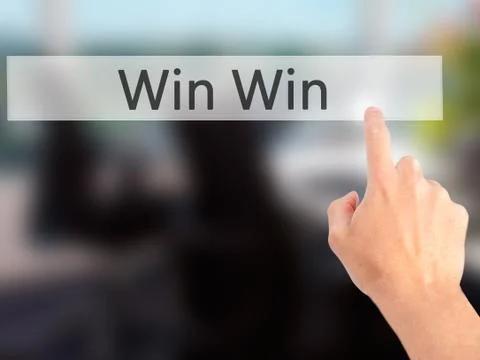 Win Win - Hand pressing a button on blurred background concept on visual scre Stock Photos