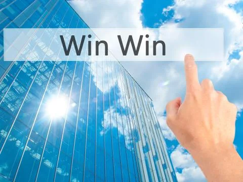 Win Win - Hand pressing a button on blurred background concept on visual scre 写真素材