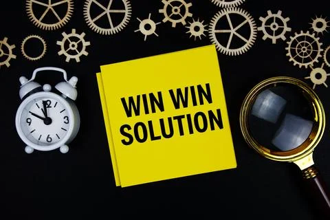 Win Win Solution text message on sticky note with magnifying glass and alar.. Stock Photos
