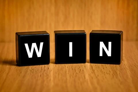 Win word on black block Stock Photos