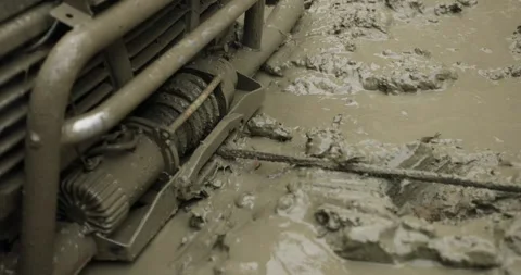 A winch with a cable is unwound in the swamp to pull the car off the road Stock Footage 245069803