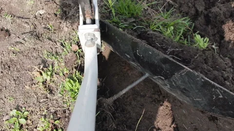 The winch pulls the cable to which the plow is attached. Plowing land on the Stock Footage 88928331