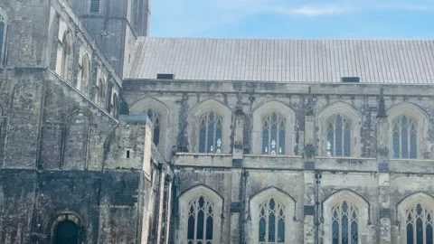 Winchester Cathedral Gothic stone facade with rose window and cathedral tower Stock Footage 340597669