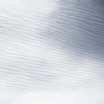 Wind affected cold snow surface highlighted with gentle, undulating textures and Stock Photos