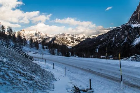 Wind and cold on a road in a winter evening in the italian dolomiti Stock Photos