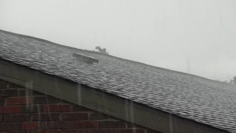 Wind and rain on 3-tab shingle roof during tropical storm Stock Footage