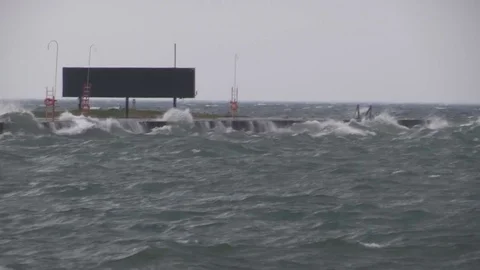 Wind and waves hit the end of the runway at Toronto island airport in storm Stock Footage 81113486