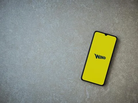 WIND app launch screen with logo on the display of a black mobile smartphone  Stock Photos