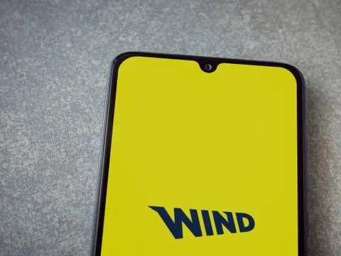WIND app launch screen with logo on the display of a black mobile smartphone  Stock Photos