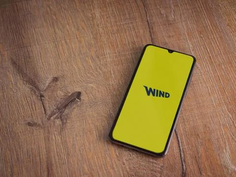 WIND app launch screen with logo on the display of a black mobile smartphone  Stock Photos