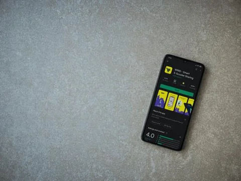 WIND app play store page on the display of a black mobile smartphone on ceram Stock Photos