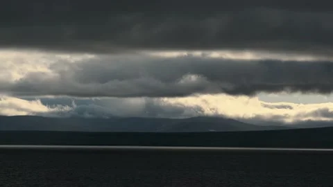 Wind bears gloomy clouds over the sea and the coast. Stock Footage 142846332