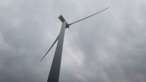 Wind blade shot from below with cloudy sky Stock Footage 136915624