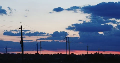 Wind blades turn generating clean energy in evening field Stock Footage 113673869