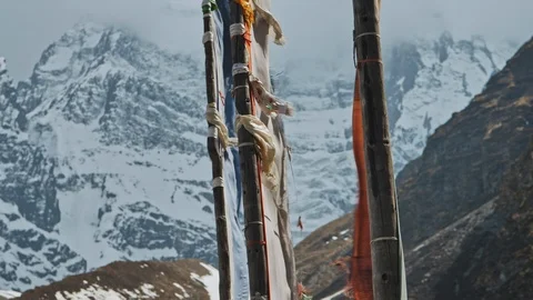 Wind blow, flags flap against severe cold snow wall of Annapurna III mountain Stock Footage 124677460