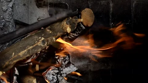 Wind blowing on burning logs in fireplace Stock Footage 292436398