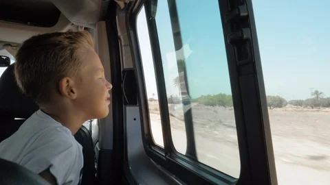 Wind blowing to child face during car journey Stock Footage 104589311