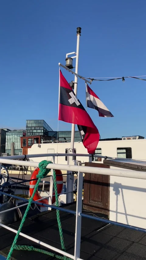 Wind blowing flags of Netherlands and municipal Amsterdam Video stock 270322922
