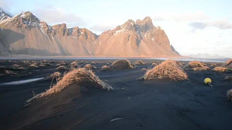 Wind blowing over black sand volcanic beach at Mount Vestrahorn, Iceland Stock Footage 56699852