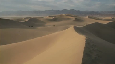Wind blowing over desert sand dunes Stock Footage 54684813