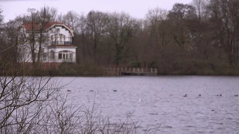 Wind Blowing over the Water, with View at Lake side Villa Stockbeeldmateriaal 86287264