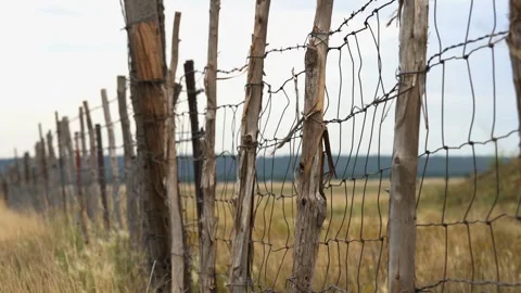The wind blowing a rustic old ranch fence in the American southwest Stock Footage 201306839