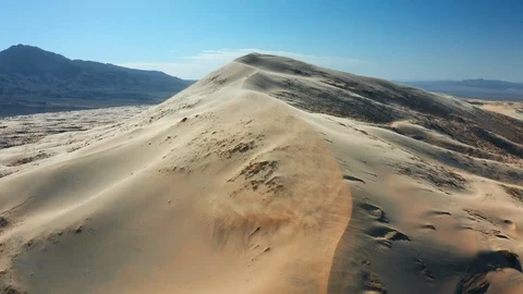 Wind Blowing Sand Across Giant Sand Dunes in California Stock Footage 127005314
