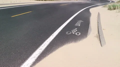 Wind blowing sand across road 스톡 동영상 25366041