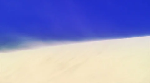 Wind blowing on sand dune against clear blue sky in Florence, Oregon Vidéo 25311181