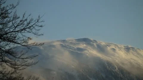 Wind blowing snow off mountain. Stock Footage 10750626
