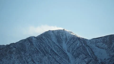 Wind blowing snow on mountain peak, East side of sierra Nevada, California Stock Footage 179873515
